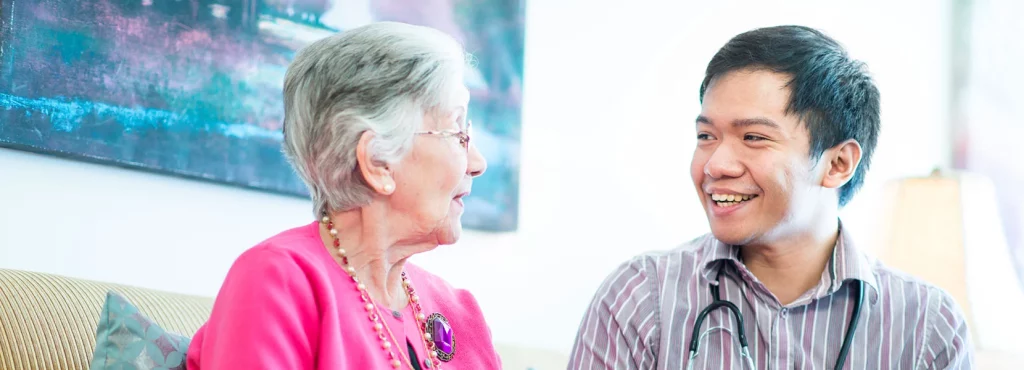 Doctor talking with senior female patient