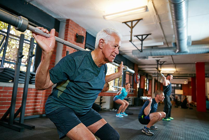 Senior man in weight training session