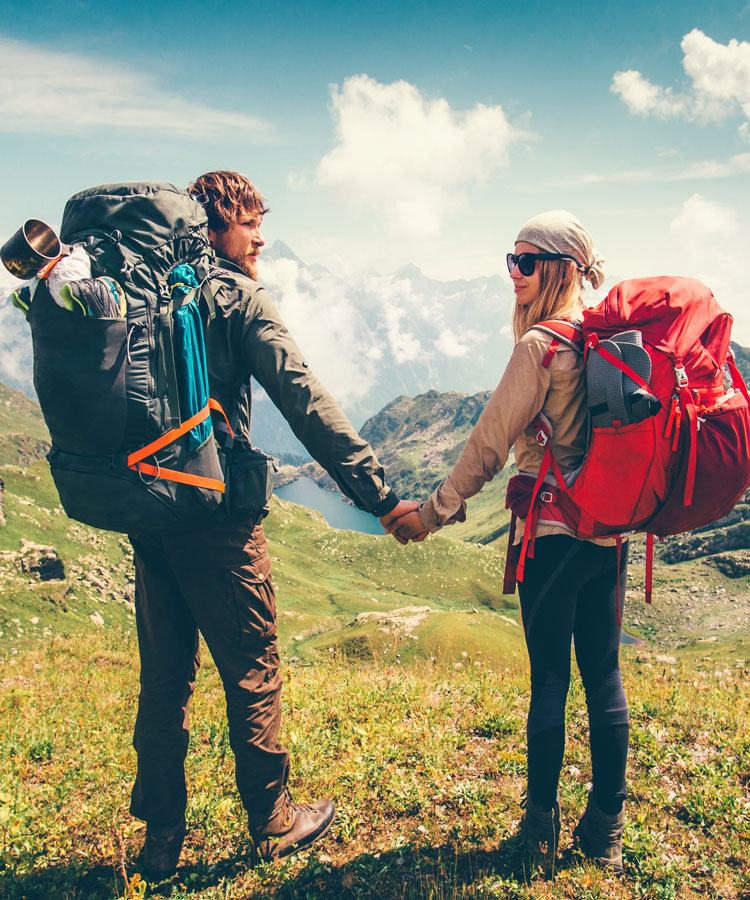 Woman and manhiking on path with packs