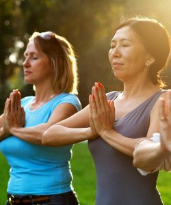 Women doing yoga outside