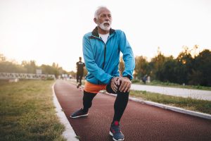 Man stretching on track