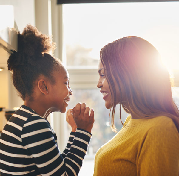 mother and daughter smiling at each other
