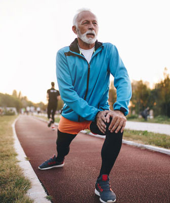 Man stretching on track