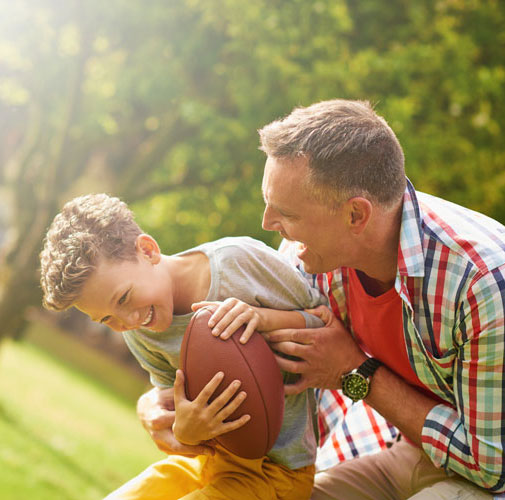 Father and son playing football