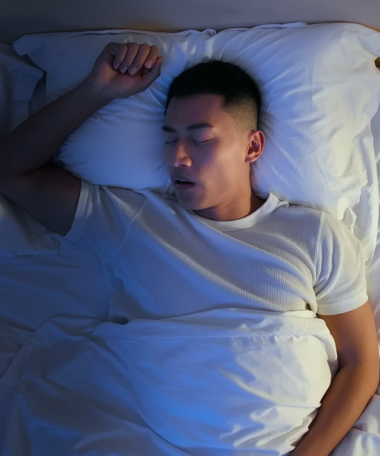 Young man sleeping on his back