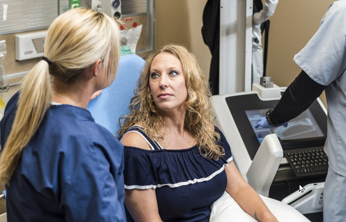 Woman looking at nurse in emergency room