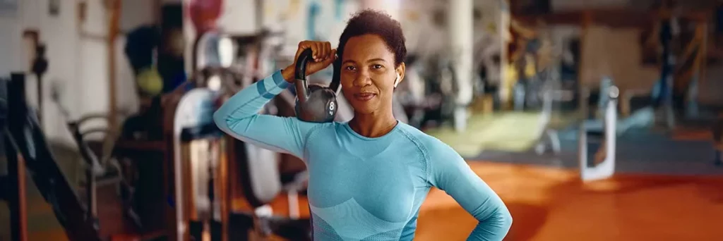 UCHealth Today strength training is vital. Woman lifting kettlebell in gym.
