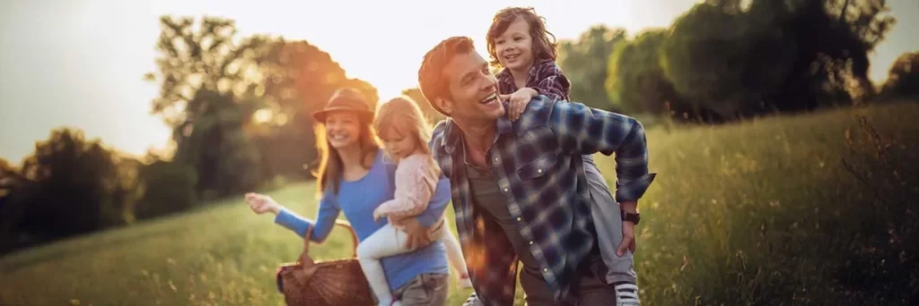 UCHealth today family in the park in the sun wearing sunscreen.