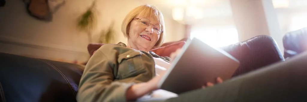 Woman on couch using Livi, UCHealth's virtual assistant.
