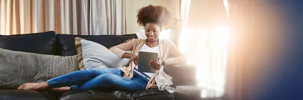 Woman on tablet, using the UCHealth website to schedule her appointments.