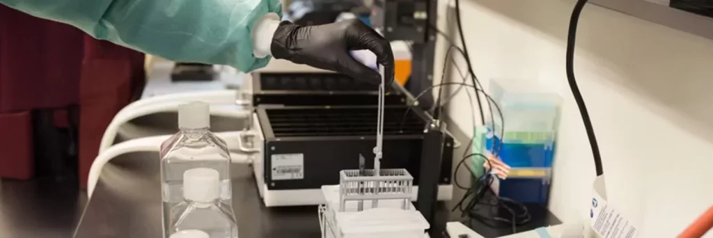 UCHealth Biobank. Laboratory worker pipetting.