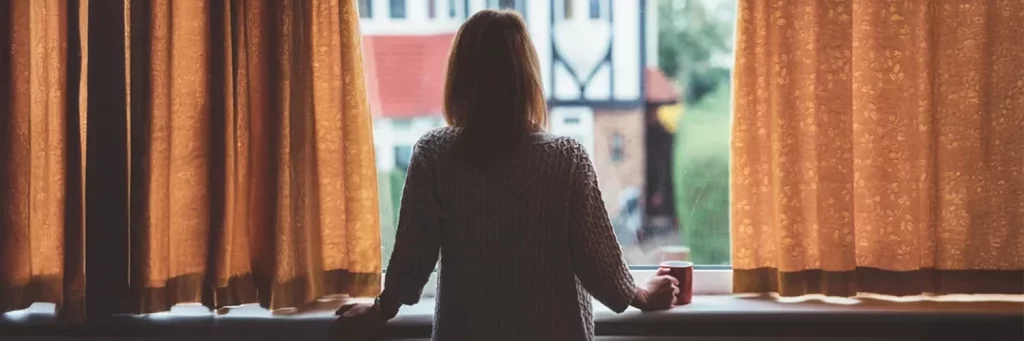 UCHealth Behavioral Health available in primary care clinics. Woman looking out window.