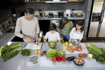 UCHealth Healthy Hearts and Minds Heart Health. Family cooking in kitchen with heart healthy ingredients.