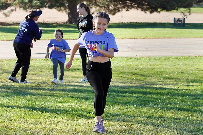 UCHealth Healthy Hearts Healthy Minds BStrong Bfit. Elementary aged girl running in race.