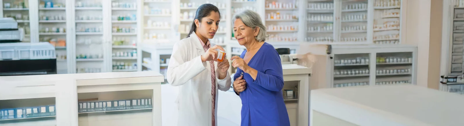 UCHealth Pharmacy Residency Program at PVH. Pharmacist reviewing medicine with patient.