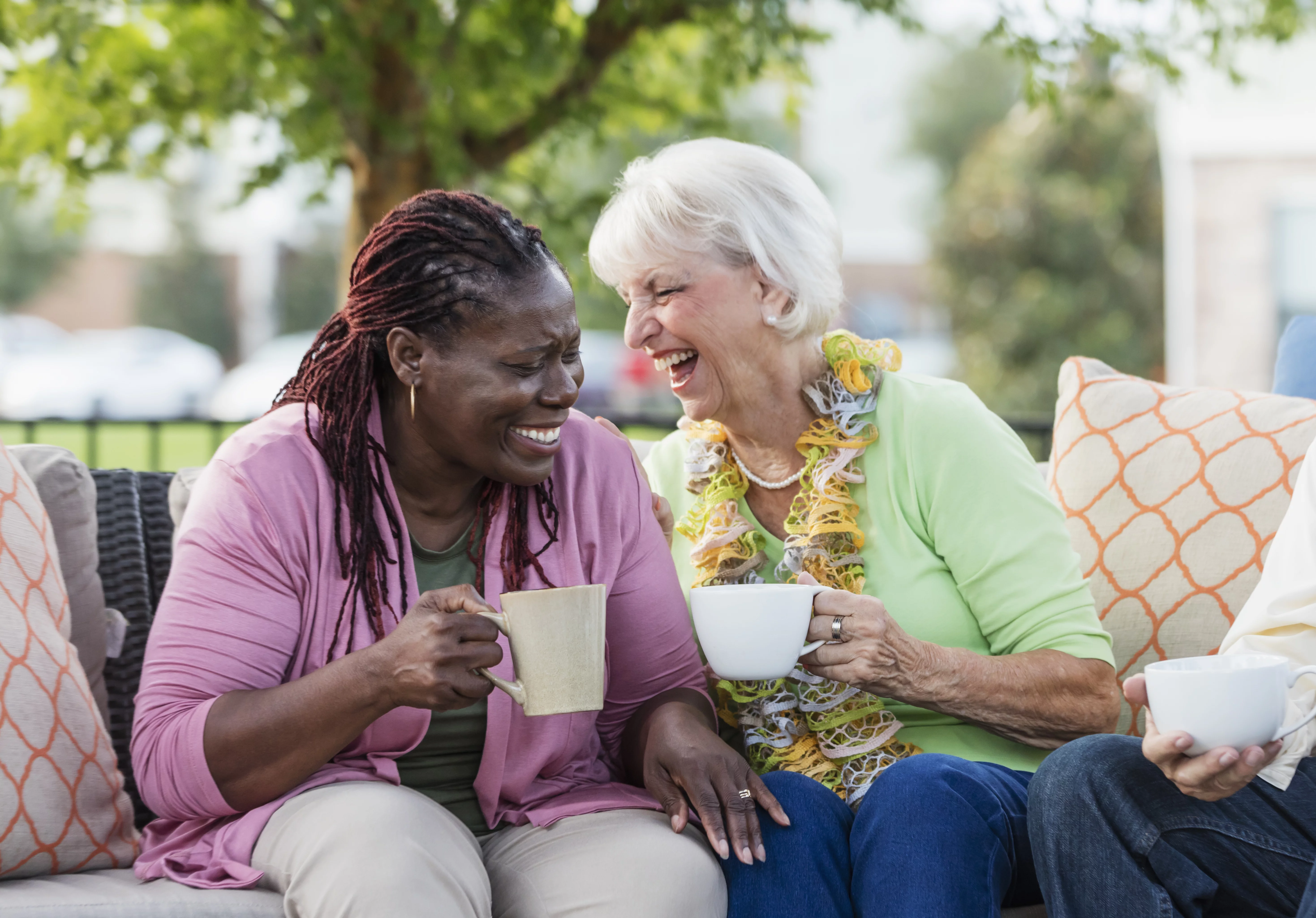 UCHealth Breast Cancer Support Group-two women laughing over coffee