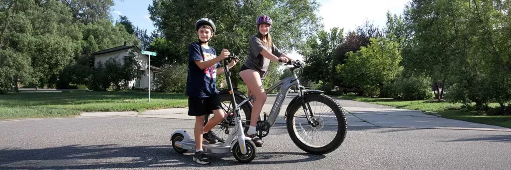 UCHealth kids on e-bikes and scooters in the street