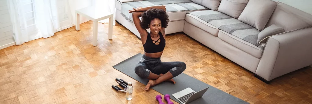 UCHealth Renal Autotransplant woman doing yoga in living room.