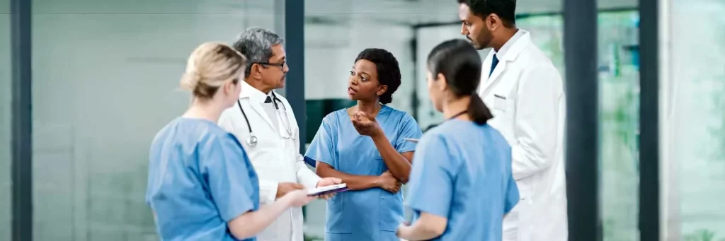 UCHealth Physician Realtions providers in a huddle in a hallway.