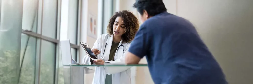 UCHealth Radiology two providers chatting over a tablet.