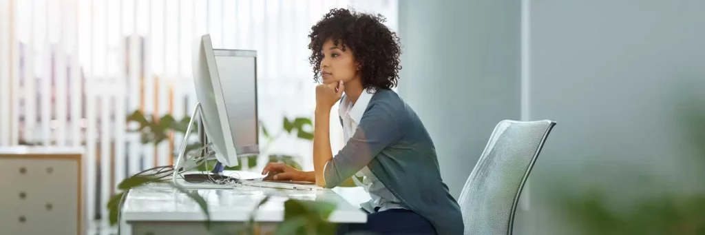 UCHealth Interventional Radiology. Woman sitting at computer in office.
