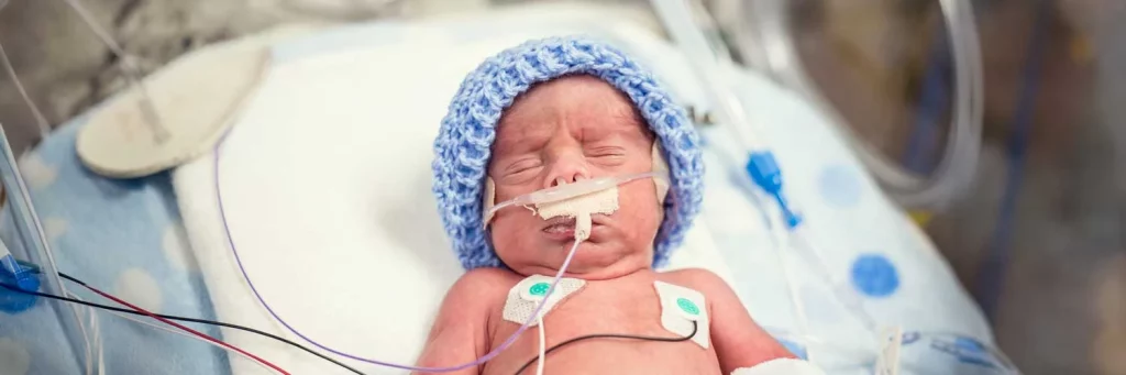 UCHealth protecting the smallest patients through reliable nurse led care. Preemie baby with knit cap on.