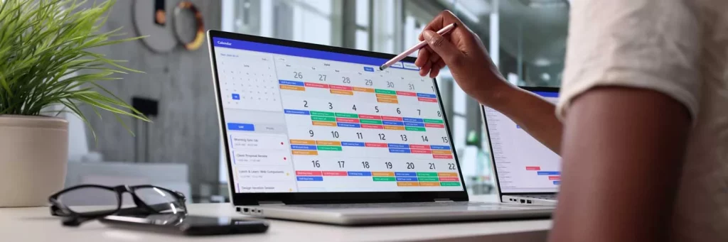 UCHealth making scheduling easier and more flexible for RNs and managers. Nurse working on computer with scheduling calendar.