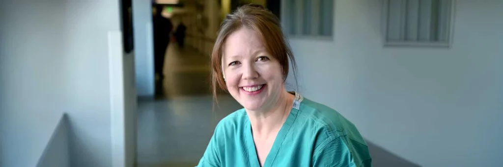 UCHealth Honoring patients final wishes for organ donation. Nurse in scrubs smiling at camera.