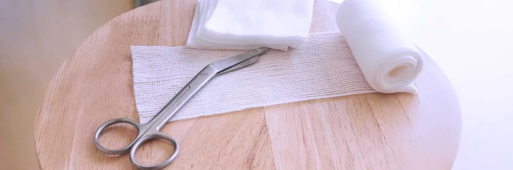 UCHealth shaping national burn nursing standards with patient centered care. Gauze and scissors on table.