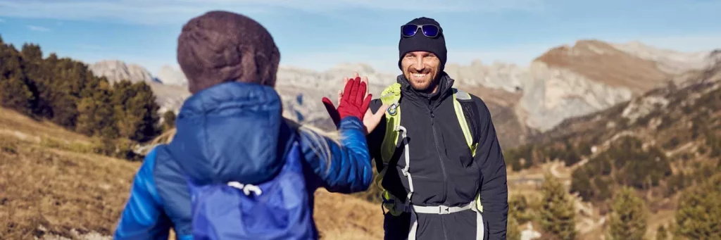 UCHealth Eye care dry eye. People high-fiving while hiking in the mountains.
