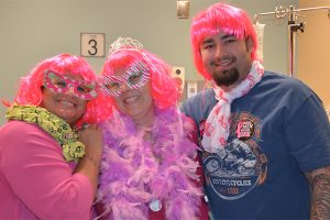 Jennifer Reid, Yvette Engel and Yvette’s son, Josh, dress up in wigs and tutus to mark the end of chemotherapy for Yvette