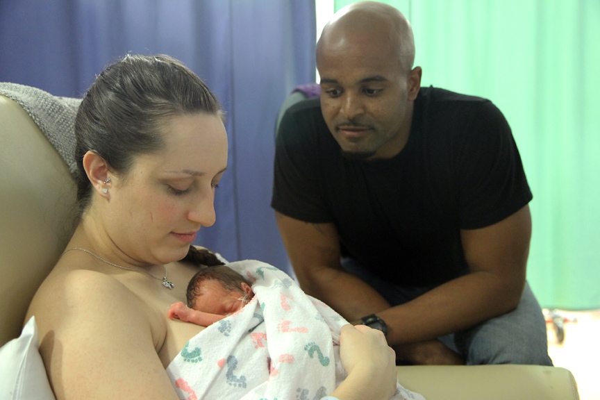 New father, David Knighton, sits with Erika Druhot while she holds her 1-week-old daughter Brielle