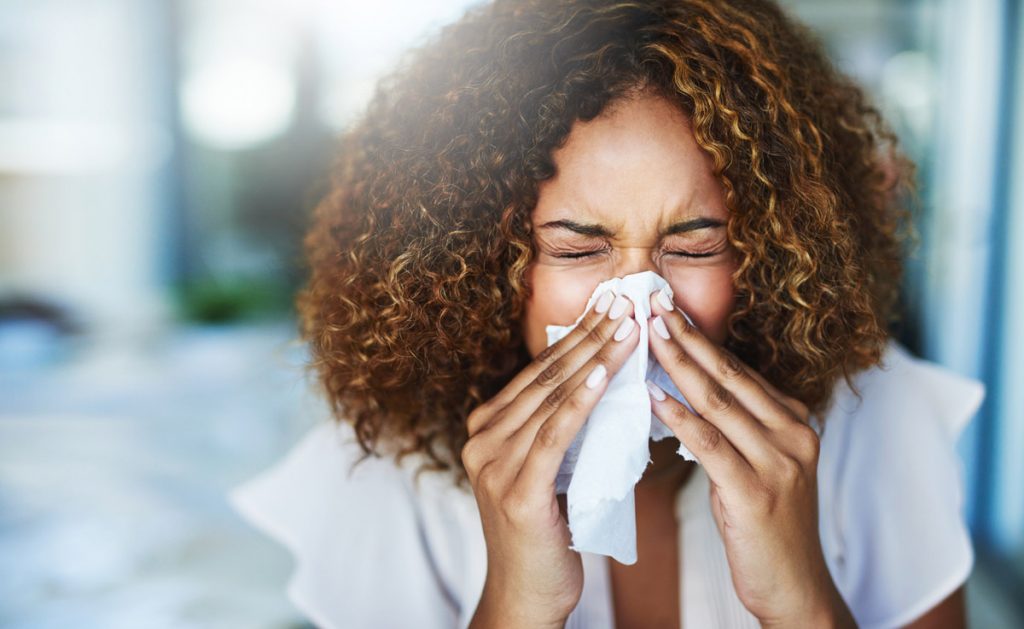 a woman sneezing