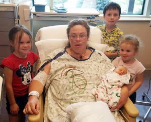 Cian, 7 (back row), Vidanna, 5 (left), and Ali, 3 with mom, Veronica Wilkins, and newborn brother, Thane, at UCHealth Medical Center of the Rockies after Wilkins had an emergency C-section and open-heart surgery in July 2016.