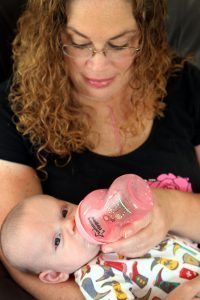 Veronica Wilkins’s scar is visible while she holds her 9-week-old son, Thane, who was born by C-section just minutes before Wilkins had emergency open-heart surgery in July 2016 at UCHealth Medical Center of the Rockies.