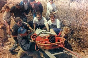 In this newspaper photo from the Coloradoan, PVH EMS paramedic Steve Main (center responder with white uniform) helps firefighters and other rescuers lift a 26-year-old hiker out of a rocky area of Horsetooth Reservoir in March 1993. The hiker was treated at PVH for facial-bone fractures, head injury and cuts and scrapes, and was later released.