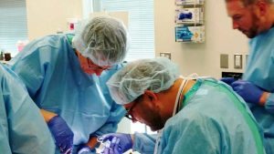 Surgeons practice in a training OR.