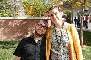 A couple poses in a photo outside.