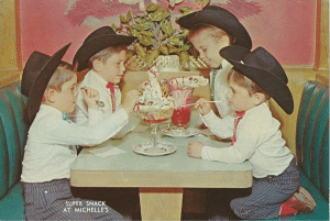 In a photo from 1960, 4 brothers enjoy treats at a soda fountain. They are all wearing cowboy hats.