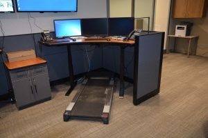 A treadmill at one of the workstations in the transfer center will allow staff to stay active during long hours. All workstations are built for standing while working.