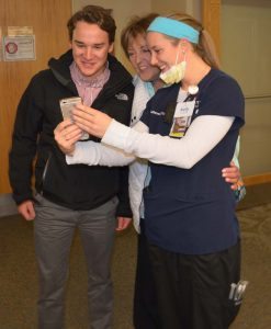 : Charge nurse Kelly Tadken uses her phone for a Facetime session with one of the BMT Unit providers who cared for Lynn Kelly.