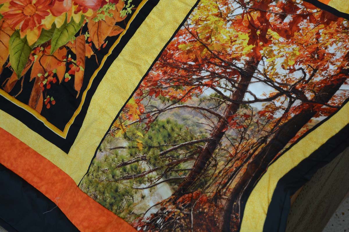 a quilt panel that shows trees and fall colors