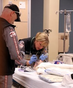 In this photo, Air Link's certified flight registered nurse Leanna Harpman puts a breathing tube into the child simulator's mouth while CFRN Duane Rorie assists.