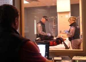 In this photo, Air Link's certified flight registered nurses Leanna Harpman and Duane Rorie work on a simulation patient while simulation educator and flight RN Ryan Bushmaker controsl the scenario from behind one-way glass.