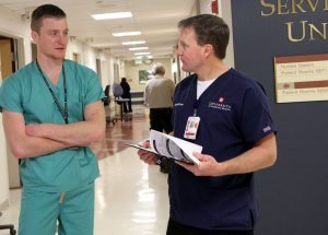 First-year resident Austin Fain is shown with RN Jimi Killen in this photo during a morning in the Medical Unit at Poudre Valley Hospital as part of the residency program there.