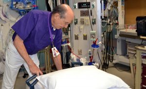 Bob Allen is shown volunteering in the Emergency Room at UCHealth Poudre Valley Hospital.