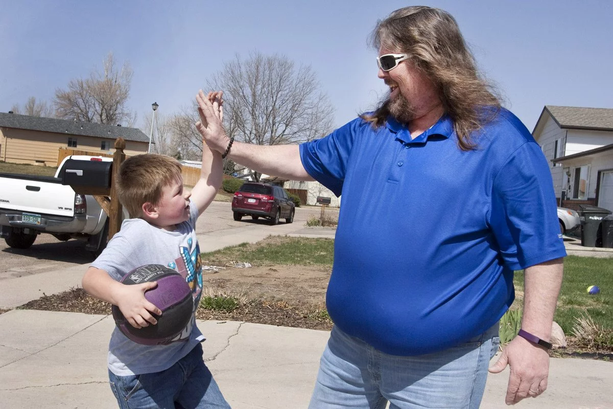 Brian Gary is shown giving his grandson a high five.