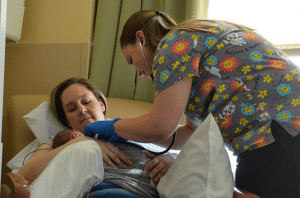 Amanda Lupton, a registered nurse at UCHealth Memorial Hospital, checks on Parker and Paisley McTague. Parker (right) weighed 5 pounds 6 ounces at birth; his sister, Paisley (left), weighed 4 pounds 4 ounces.