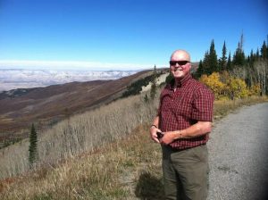 Erin Mousey, who was burned in an explosion, stands on top of a Colorado pass.