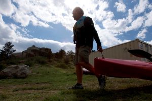 Stan Kepley pulls his kayak toward the water at Curt Gowdy State Park west of Cheyenne, Wyoming.